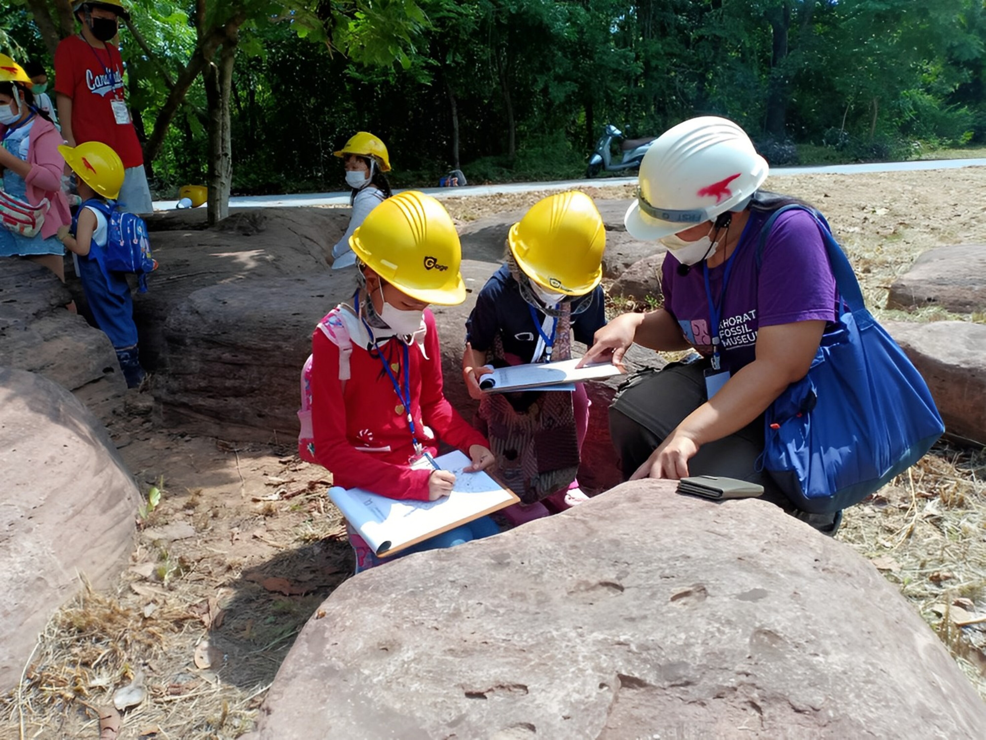 School children look for fossils during an educational activity in Khorat UNESCO Global Geopark, Thailand