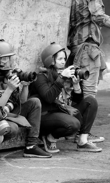 A group of journalists in action, including women 