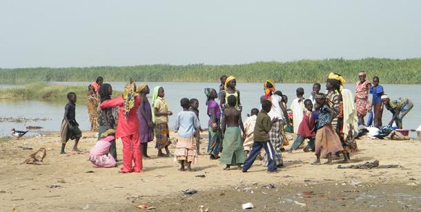adults and children meeting in front of Lake Chad
